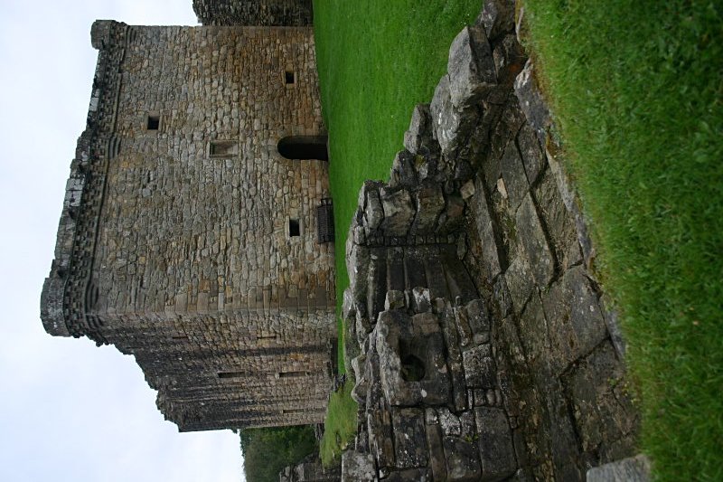 The tower keep and ruins of a rampart tower from the northwest.