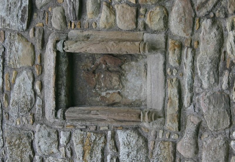 Crumbling coat of arms in the keep wall.