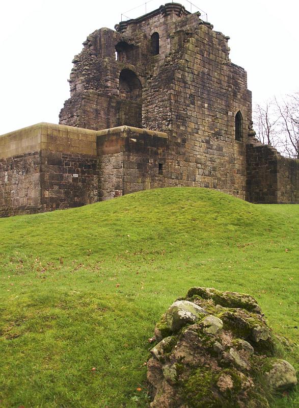 Looking from the southwest.  Bumps in the ground and bits of fallen wall are all that remain of the southwest tower.