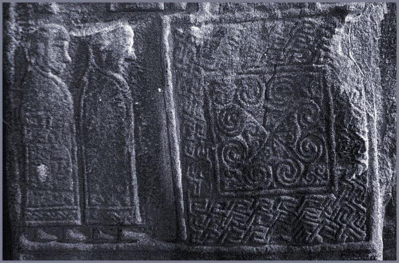 A pair of tonsured monks and a key-pattern panel.