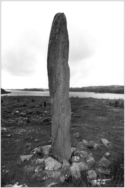  The monolith at Kintraw with Loch Craignish behind. The remains of a kerb cairn lie behind and to the left of the stone.