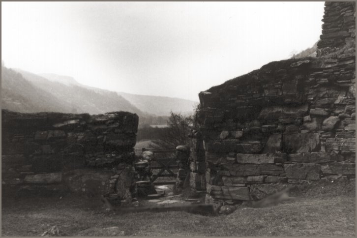 View from the courtyard through the entrance and down the glen on a hazy day. If you know what you are looking for, Dun Telve can be seen through the entrance.