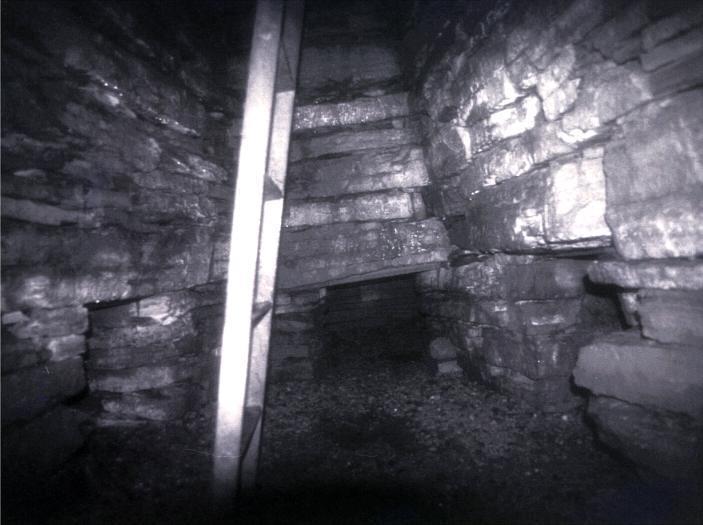 The inside of the tomb looking south.  The entrance passage is through the opening to the right of the picture.  Present day access is through a hatch in the roof - hence the ladder
