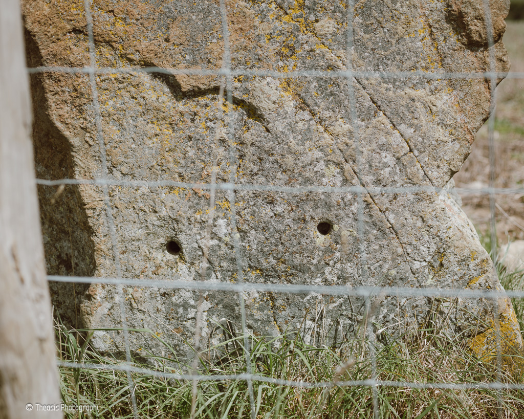 Holes drilled in the base of the south face.