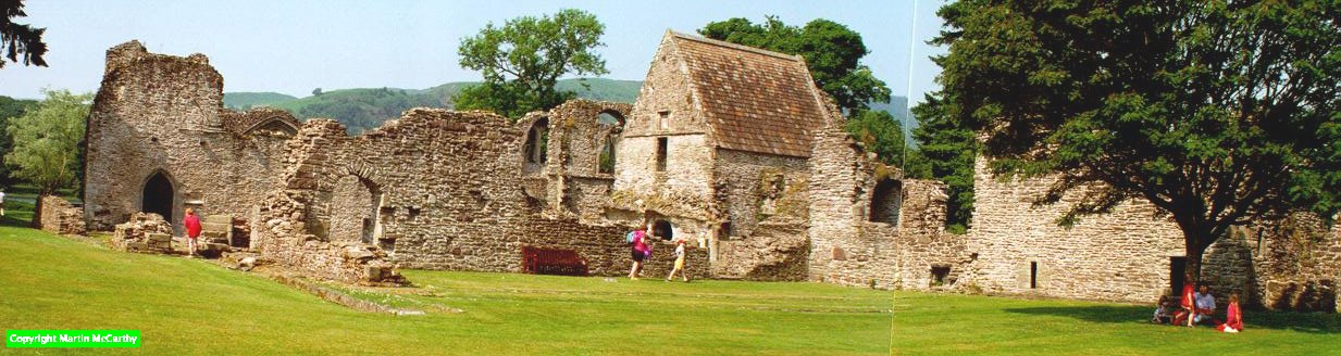    View of the priory from the south-west. You see, from the left: the West Range; the Nave; the Chapter House; the East Range. onto the lake.