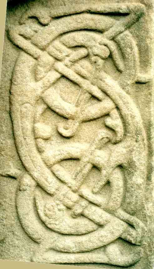 Detail of the interlaced creatures at the centre-right of the cross side.