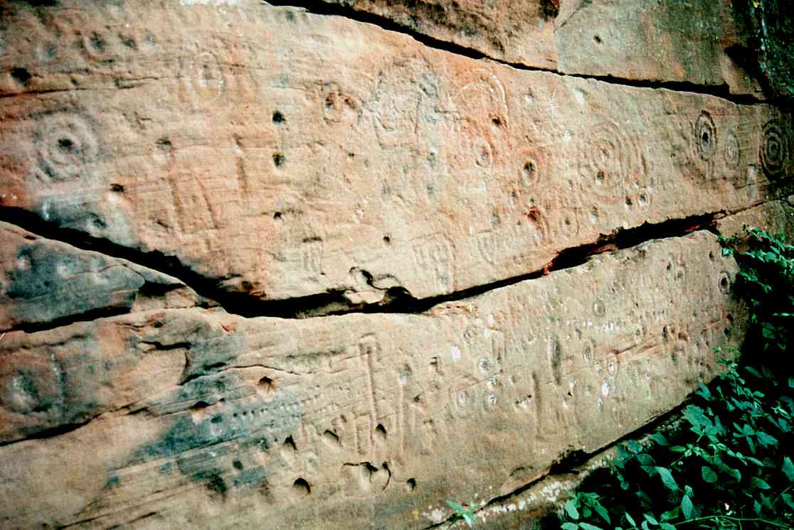  A view of the left-hand face showing rows of cups and unusual rectangular marks.