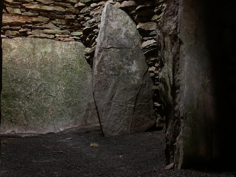 The back wall of the main chamber of the southerly "sub-cairn".  The roughly rectangular shape is defined by a large slab making up the back wall and four upright megaliths in the corners.