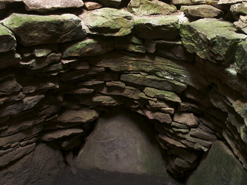 The back wall of the main chamber of the northerly "sub-cairn". This chamber is rounder than the chamber to the south, with several large slabs making up a significant part of the wall.