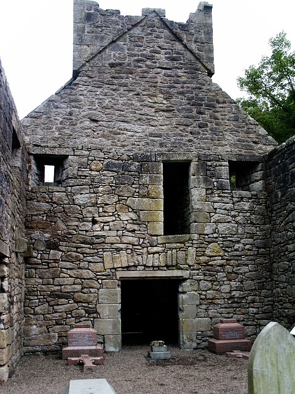 Inside the church looking towards the tower in the west end. The ground floor doorway has clearly been altered with a lintel made from a single stone underneath the older keyed lintel.  The gravestones are 19th century or later.