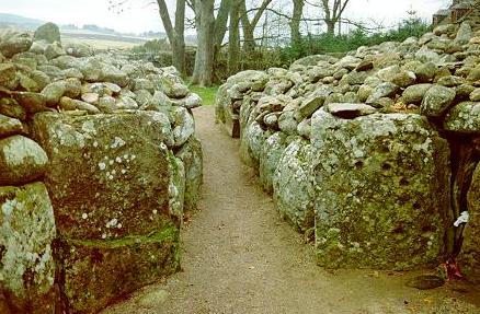 Looking south out of the South-West passage cairn at Clava, near Inverness. The stone to the right of the passage contains several cup-mark carvings.