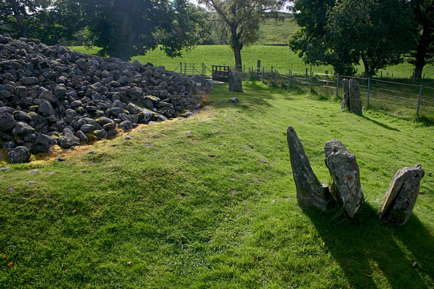 The southwestern arc of the circle.  The triple stone in the foreground is a late addition, possibly using lintel stones from the cairn or actual standing stones from the original circle.