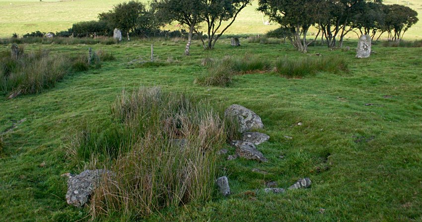 Remains of a possible cairn within the circle in the foreground. The northwestern arc behind.