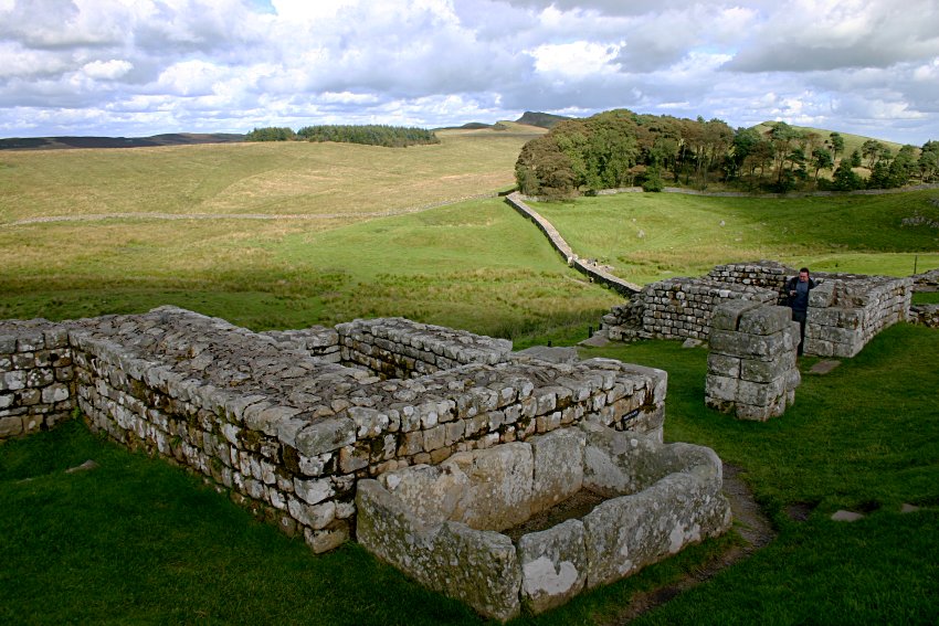 The north gate looking northeast with Hadrian's Wall running from the fort to the trees.
