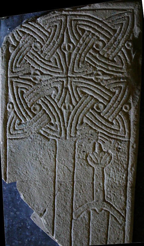 Part of a graveslab with a fine interlaced cross inside the chapter house.