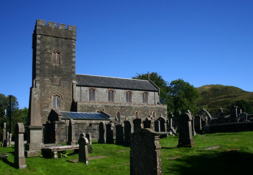 The church and graveyard.  The mausoleum containing the mediaeval slabs is the low stone building this side of the church tower.