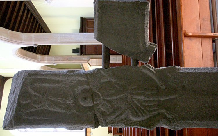 Rear of the early stone crucifix, now protected inside the church.