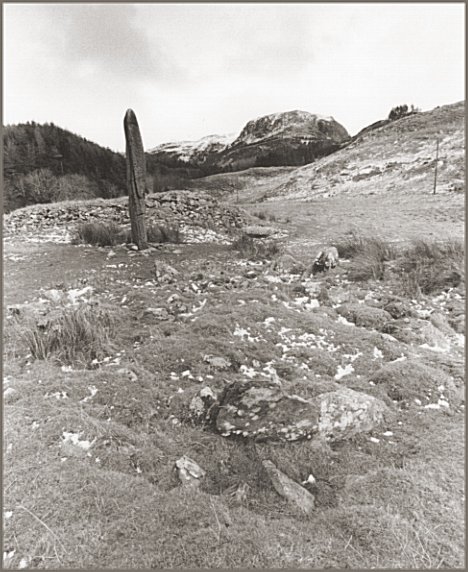  Looking northeast with a kerb cairn in the foreground and the least robbed cairn behind the monolith.