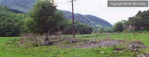 View from the south-east. The dark area running across the cairn just to this side of the bronze-age telegraph pole(!) is a passage within the cairn. 