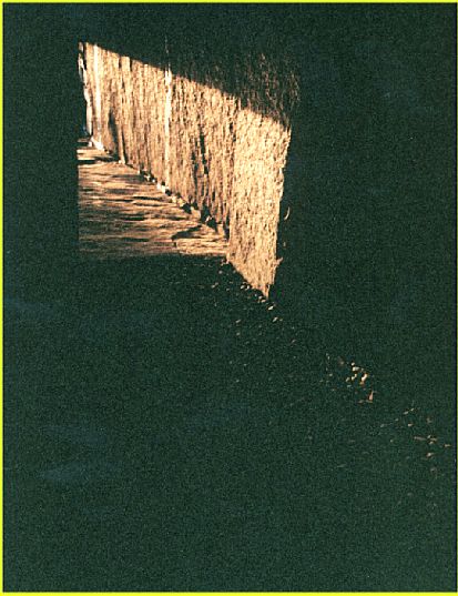  Light from the mid-winter sunset edges past the doorway of Maeshowe and starts to spill across the floor of the main chamber.
