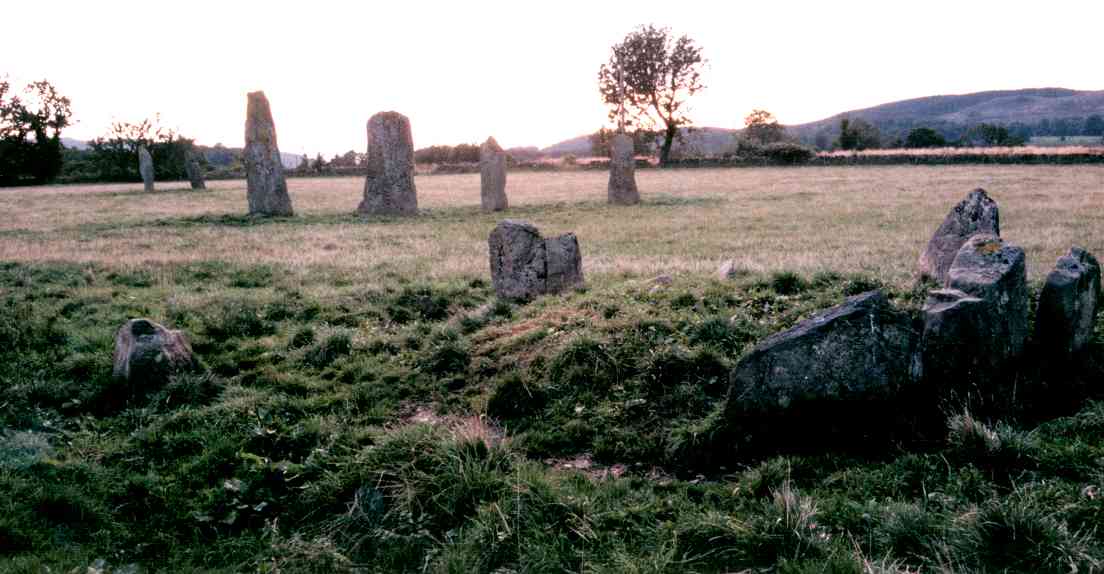 In the foreground is the cairn, with the two stone rows behind