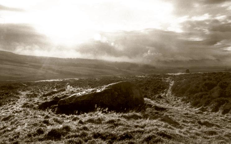 The northernmost stone of the row, looking southwest as the mist lifts from the moor.  The second stone in the row, the Wallace Stone, can be seen to the right in the distance.