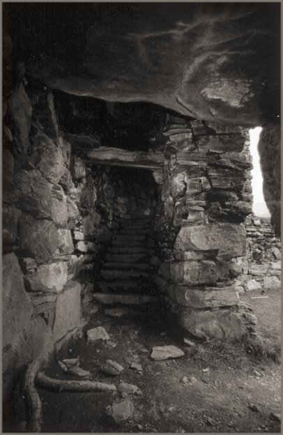  Inside the wall space; the broch courtyard through the entrance on the right and steps leading up ahead