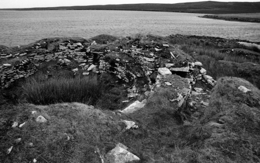 Looking northeast into the body of the broch.  The double-wall can be seen in the lower right.  A large space, suitable for storage, is in the wall cavity below stone covers immediately below my feet.